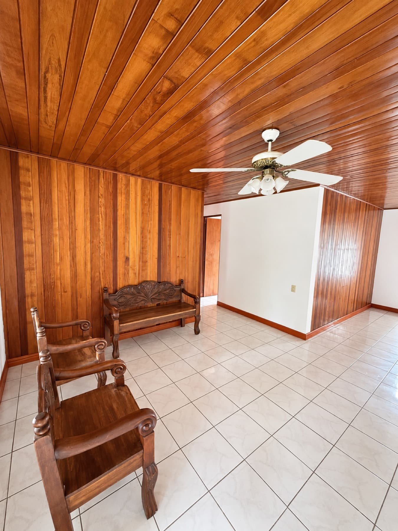 Living room with wood ceiling and large windows